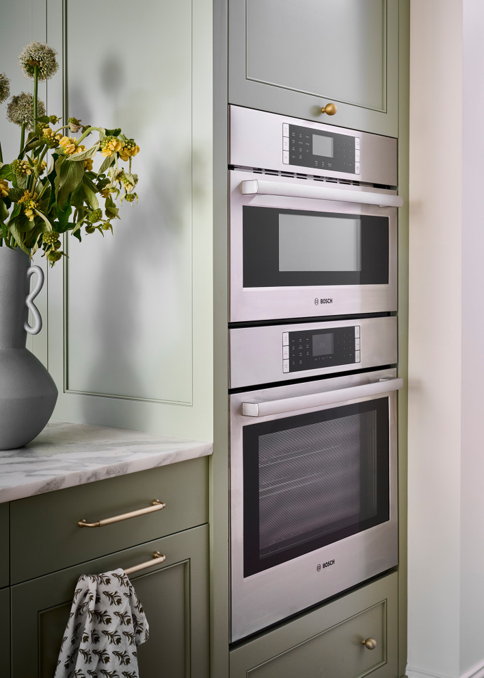 Inspiration for a mid-sized transitional galley medium tone wood floor and brown floor open concept kitchen remodel in Atlanta with an undermount sink, recessed-panel cabinets, green cabinets, marble countertops, white backsplash, marble backsplash, paneled appliances, an island and white countertops