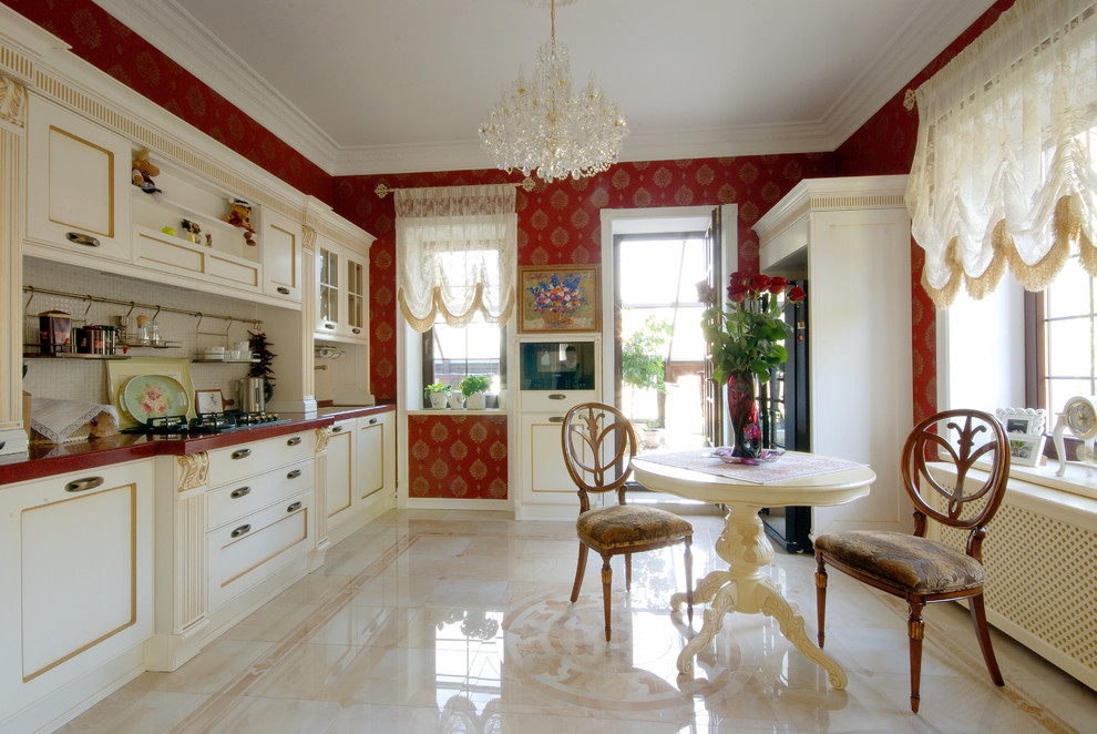 Photo of a large traditional separate kitchen in Other with recessed-panel cabinets, white cabinets, quartzite benchtops, white splashback, mosaic tile splashback and marble floors.