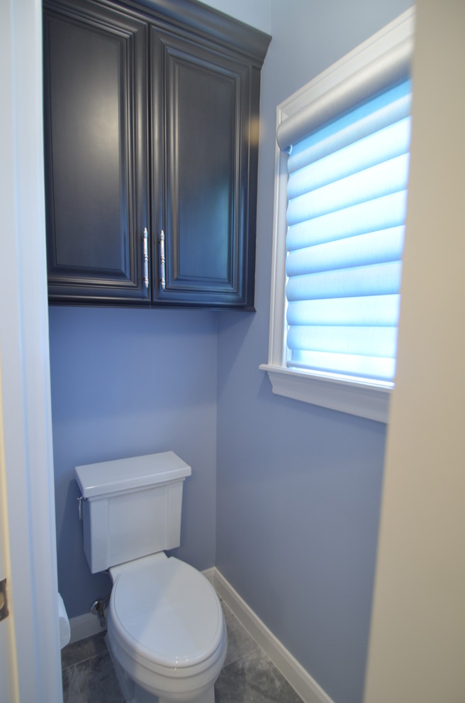 Freestanding bathtub - large transitional master gray tile and stone tile marble floor freestanding bathtub idea in Houston with furniture-like cabinets, dark wood cabinets, a two-piece toilet, blue walls, an undermount sink and marble countertops