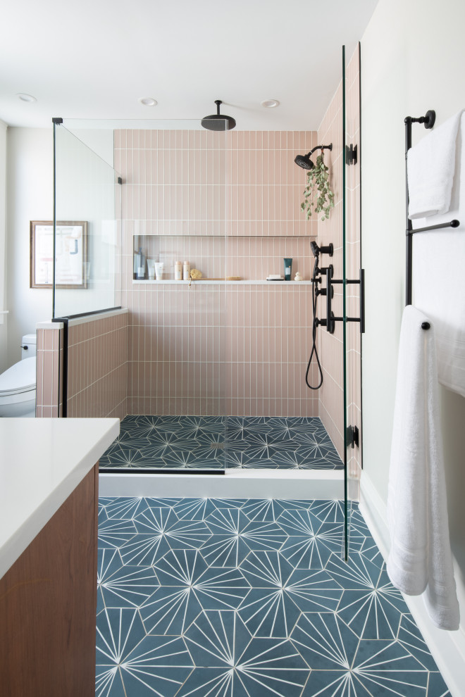 Inspiration for a large transitional master bathroom in Chicago with flat-panel cabinets, brown cabinets, a corner shower, a bidet, pink tile, glass tile, white walls, concrete floors, an undermount sink, engineered quartz benchtops, blue floor, a hinged shower door, white benchtops, a niche and a single vanity.