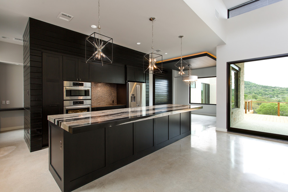This is an example of a large contemporary l-shaped eat-in kitchen in Austin with a farmhouse sink, shaker cabinets, black cabinets, metallic splashback, stainless steel appliances, concrete floors and with island.