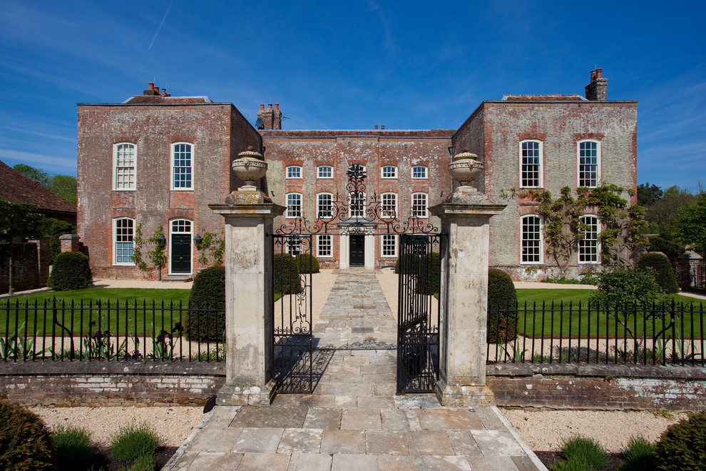 Expansive country three-storey brick grey exterior in Hampshire.