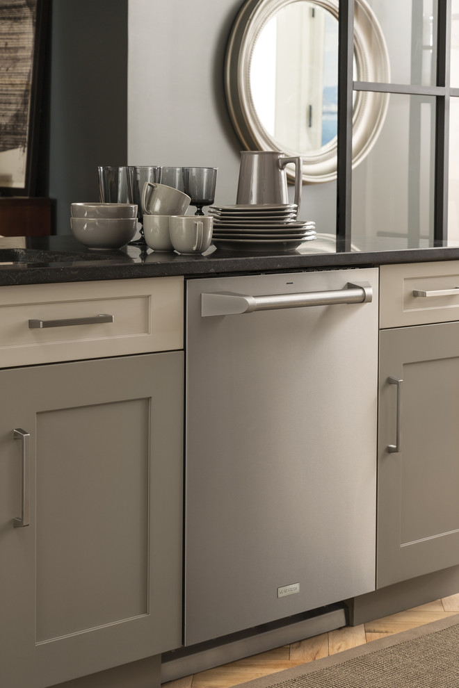 Inspiration for a mid-sized transitional l-shaped medium tone wood floor and brown floor open concept kitchen remodel with stainless steel appliances, an undermount sink, shaker cabinets, white cabinets, granite countertops, white backsplash, porcelain backsplash and an island