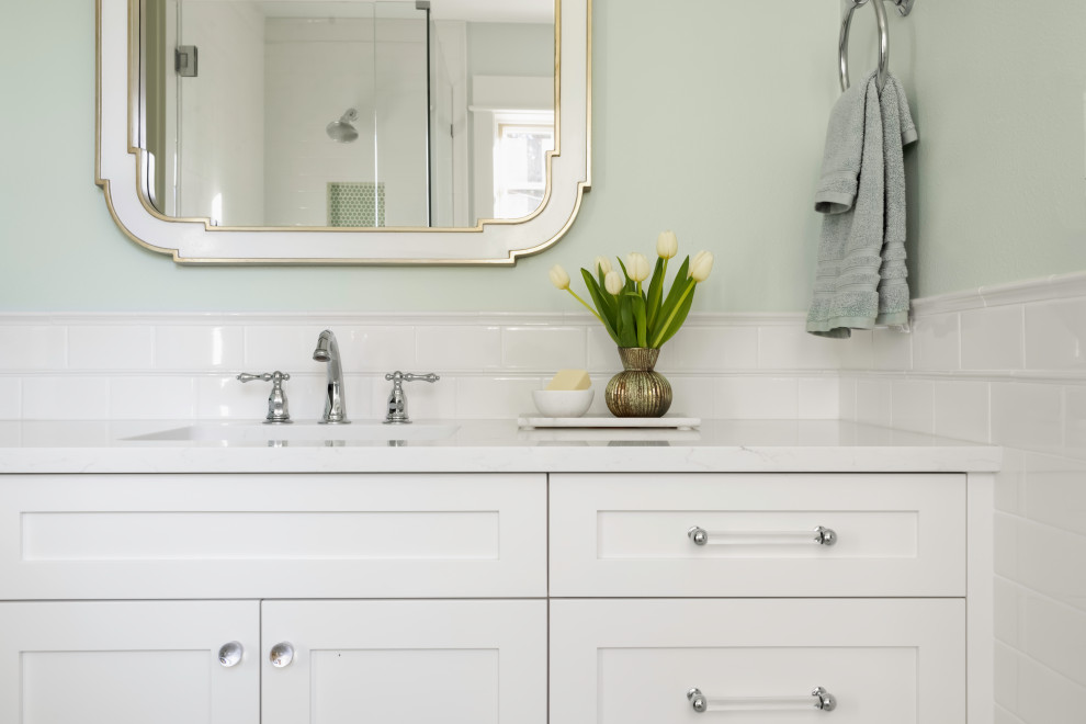 Inspiration for a large classic ensuite bathroom in Seattle with recessed-panel cabinets, white cabinets, a corner shower, a two-piece toilet, white tiles, green walls, mosaic tile flooring, a submerged sink, engineered stone worktops, green floors, a hinged door, white worktops, double sinks, a built in vanity unit and porcelain tiles.