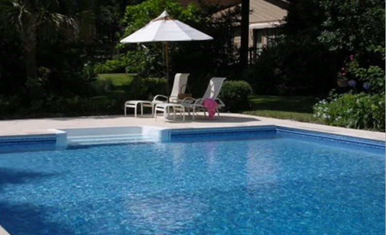 Inspiration for a large transitional backyard pool remodel in Miami