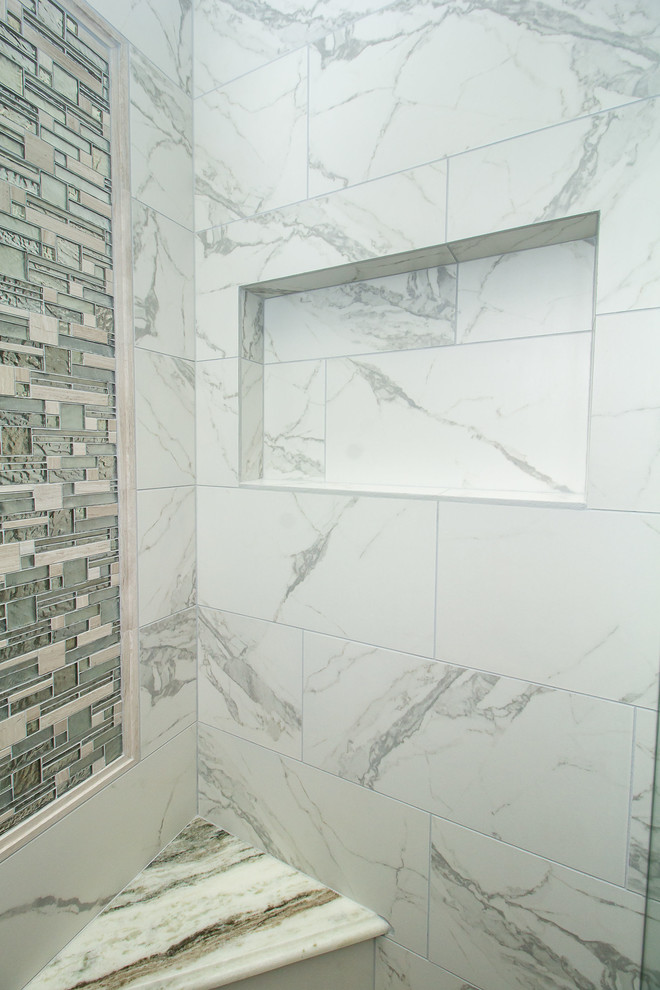 Inspiration for a mid-sized transitional master bathroom in Houston with raised-panel cabinets, white cabinets, a corner tub, an alcove shower, white tile, porcelain tile, black walls, porcelain floors, an undermount sink, marble benchtops, grey floor and a hinged shower door.