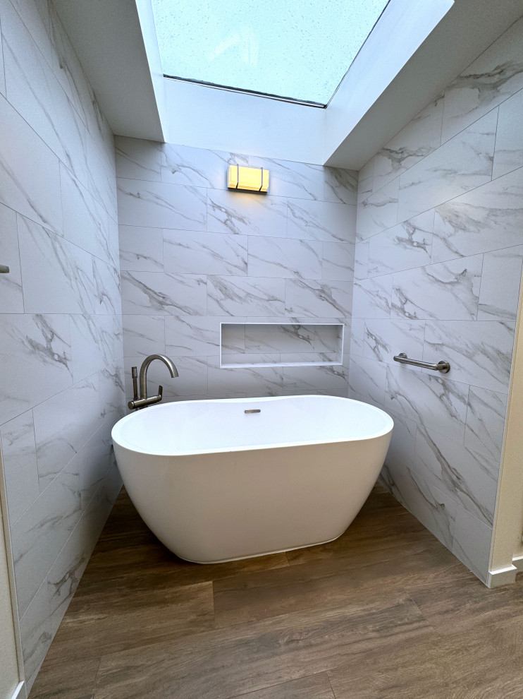Bathroom - master white tile light wood floor, brown floor, double-sink and wood ceiling bathroom idea in Seattle with a one-piece toilet, white walls and a freestanding vanity