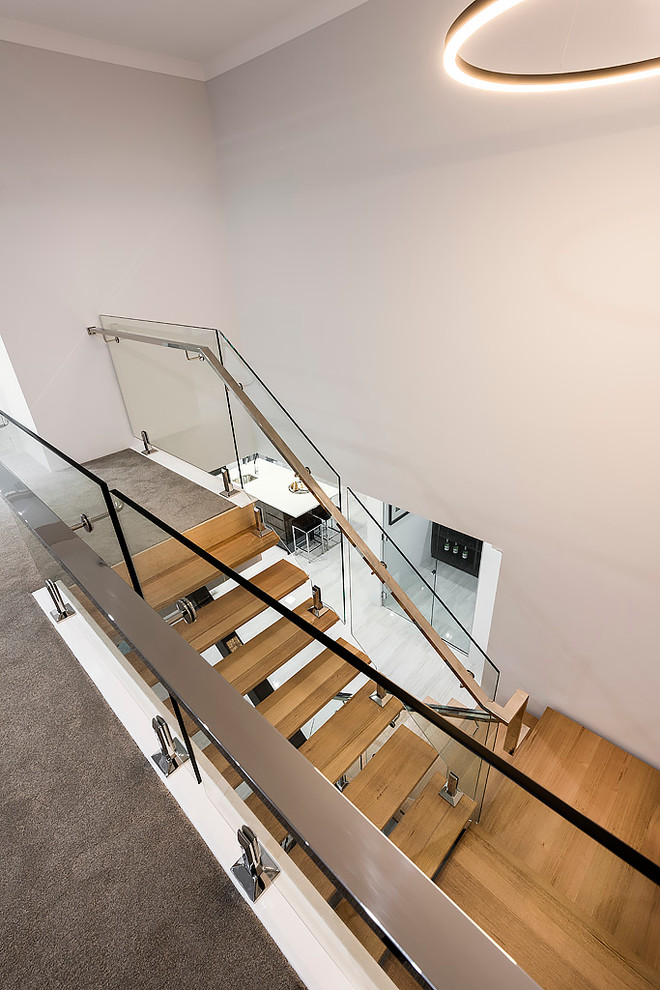 Photo of a mid-sized contemporary wood floating staircase in Perth with open risers.
