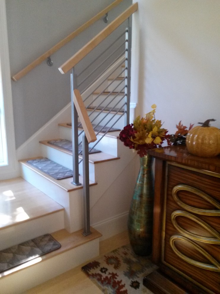 Design ideas for a mid-sized transitional carpeted straight staircase in Boston with wood risers.