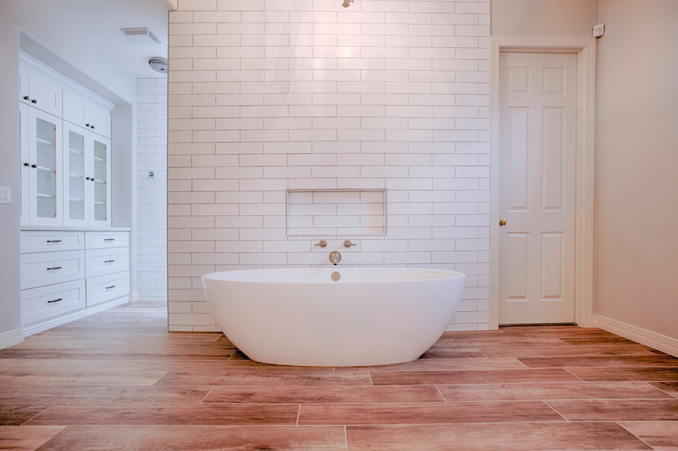 Inspiration for a huge transitional master brown tile and porcelain tile porcelain tile freestanding bathtub remodel in Phoenix with shaker cabinets, white cabinets, a two-piece toilet, gray walls, an undermount sink and quartzite countertops