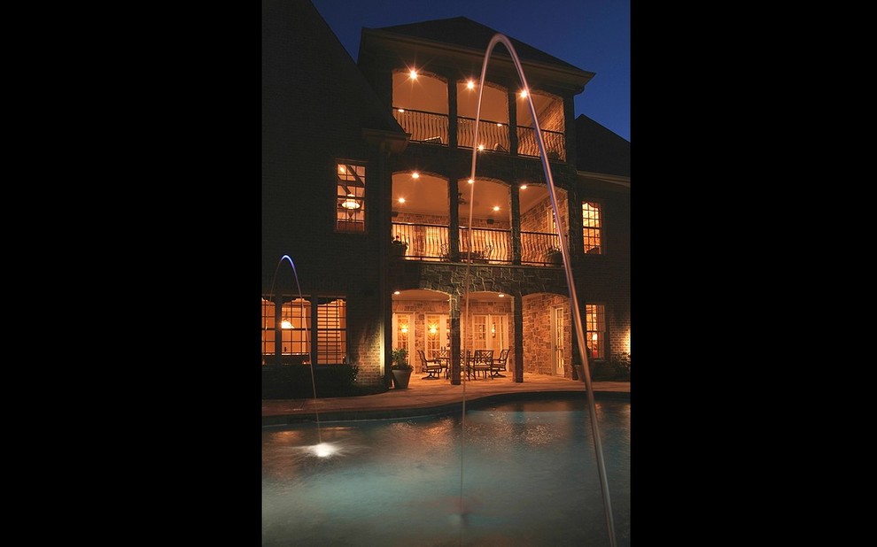 Example of a large transitional backyard concrete paver and custom-shaped lap pool fountain design in Charlotte
