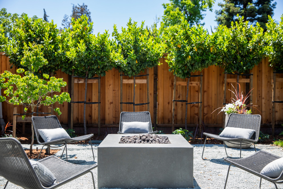Design ideas for a large farmhouse back patio in San Francisco with gravel and no cover.
