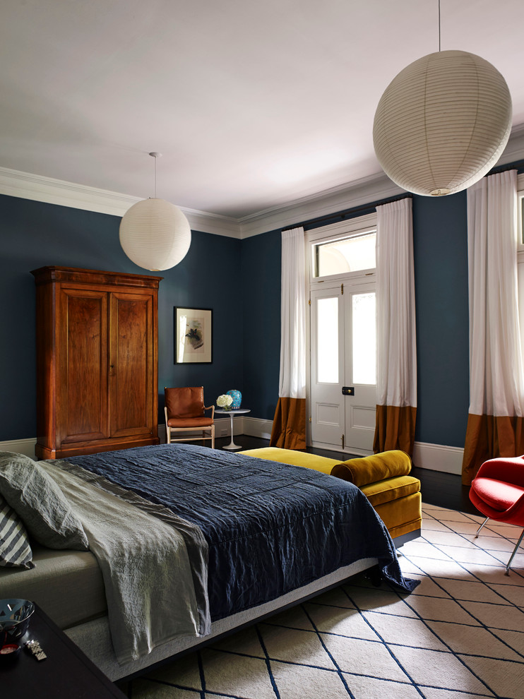 Contemporary master bedroom in Sydney with blue walls and dark hardwood floors.