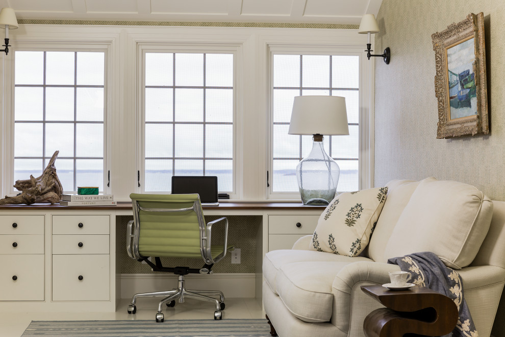 Beach style study room in Boston with beige walls, a built-in desk and white floor.