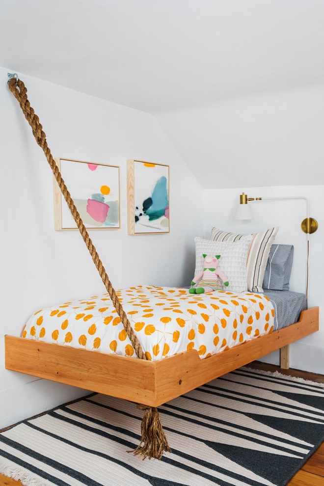 This is an example of a beach style kids' room in Boston with white walls.