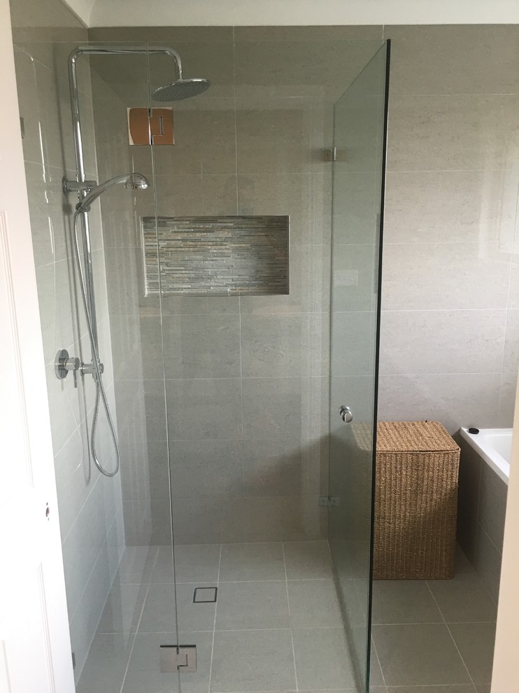 Inspiration for a mid-sized modern master bathroom in Sydney with flat-panel cabinets, white cabinets, a freestanding tub, a corner shower, a one-piece toilet, beige tile, ceramic tile, beige walls, ceramic floors, a vessel sink, engineered quartz benchtops, beige floor and a hinged shower door.