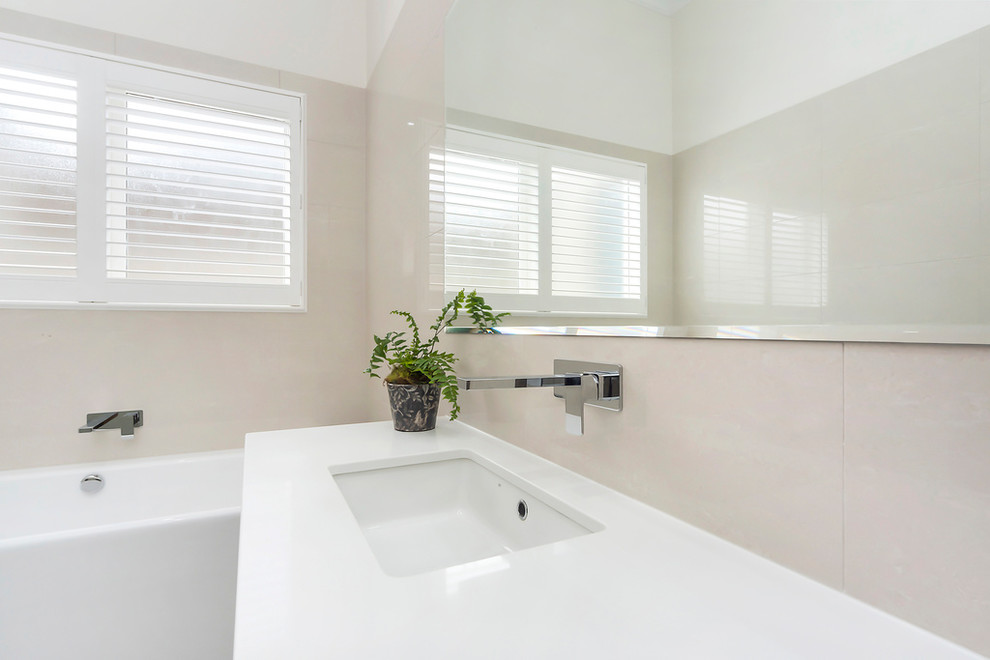 Photo of a contemporary bathroom in Adelaide with flat-panel cabinets, dark wood cabinets, a freestanding tub, an alcove shower, a two-piece toilet, beige tile, beige walls, an undermount sink and an open shower.