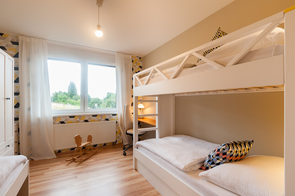 Small contemporary gender-neutral kids' bedroom in Other with light hardwood floors and multi-coloured walls for kids 4-10 years old.