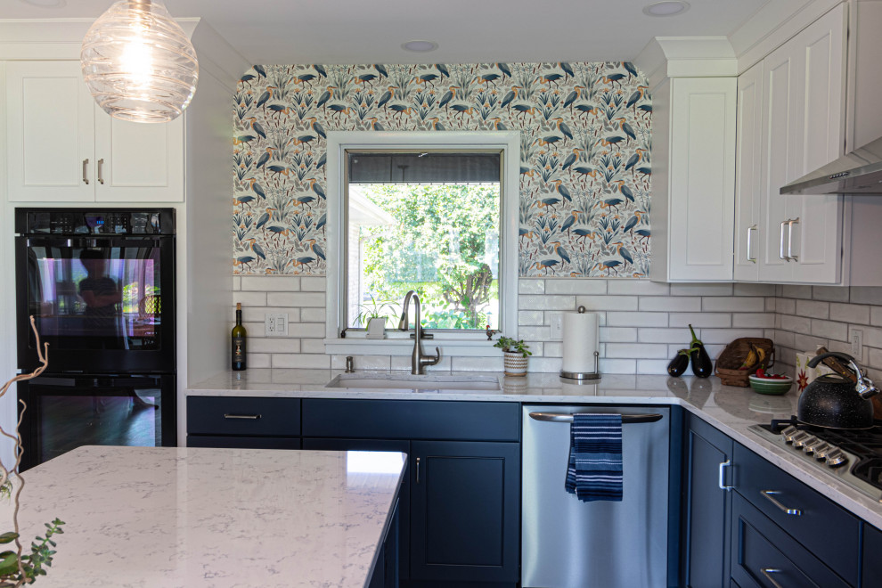 Eat-in kitchen - mid-sized transitional l-shaped porcelain tile and gray floor eat-in kitchen idea with an undermount sink, flat-panel cabinets, white cabinets, quartz countertops, white backsplash, subway tile backsplash, stainless steel appliances, an island and white countertops
