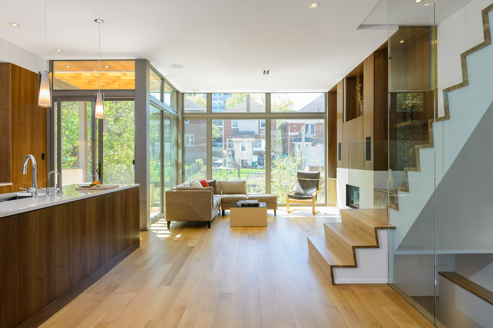 Photo of a contemporary open concept living room in Ottawa with medium hardwood floors.