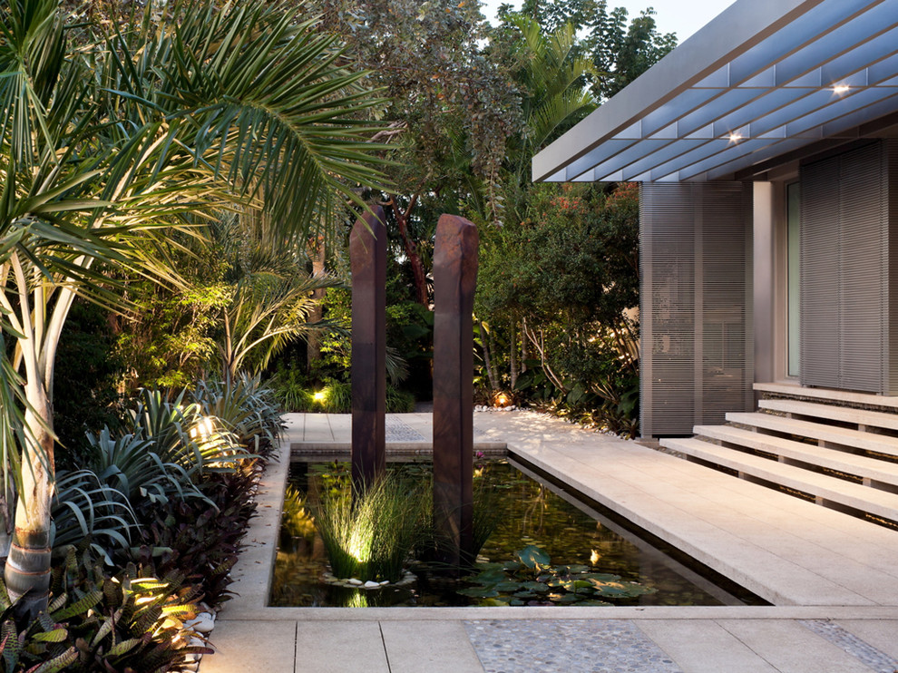This is an example of a tropical garden in Miami with a water feature.