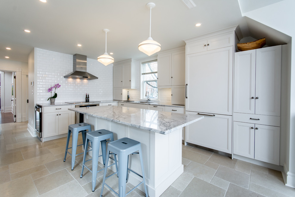 Example of a mid-sized transitional l-shaped cement tile floor eat-in kitchen design in Toronto with shaker cabinets, white cabinets, an island, an undermount sink, marble countertops, white backsplash, subway tile backsplash and stainless steel appliances