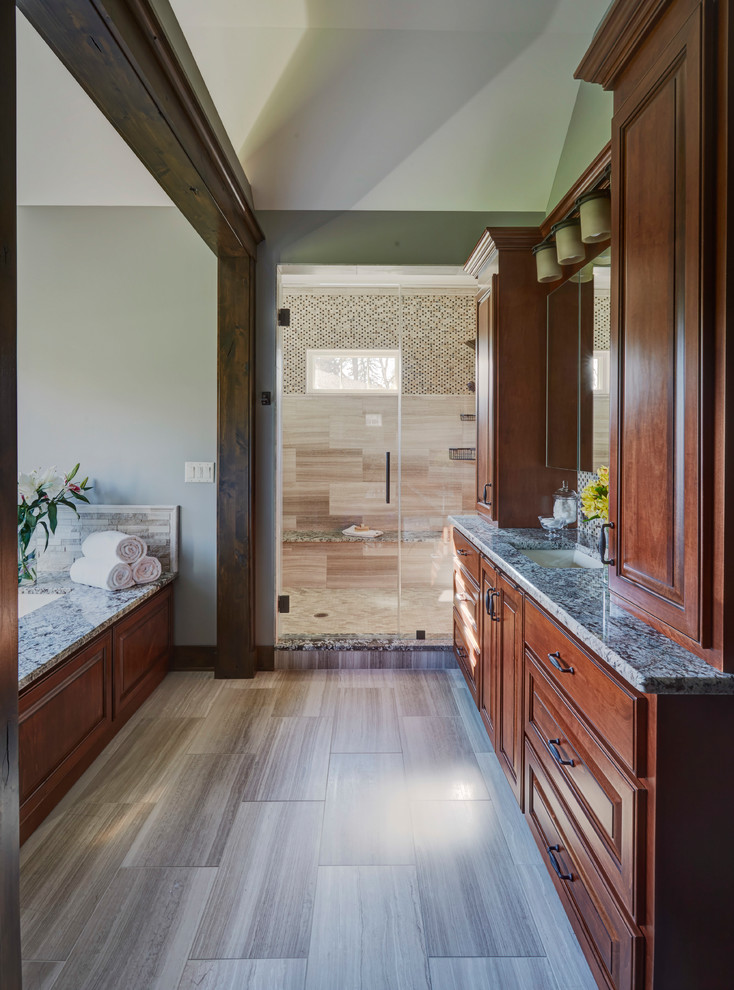Expansive country master bathroom in Chicago with shaker cabinets, dark wood cabinets, a drop-in tub, an alcove shower, green tile, porcelain floors, an undermount sink, granite benchtops, multi-coloured floor and a hinged shower door.