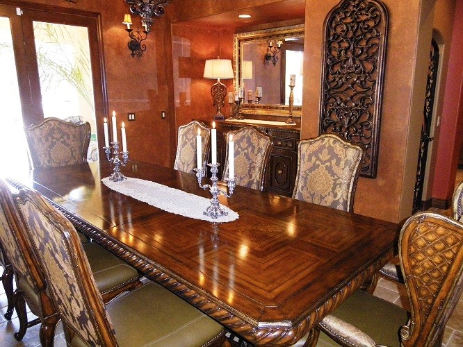 This is an example of a large traditional dining room in San Diego with multi-coloured walls and travertine floors.
