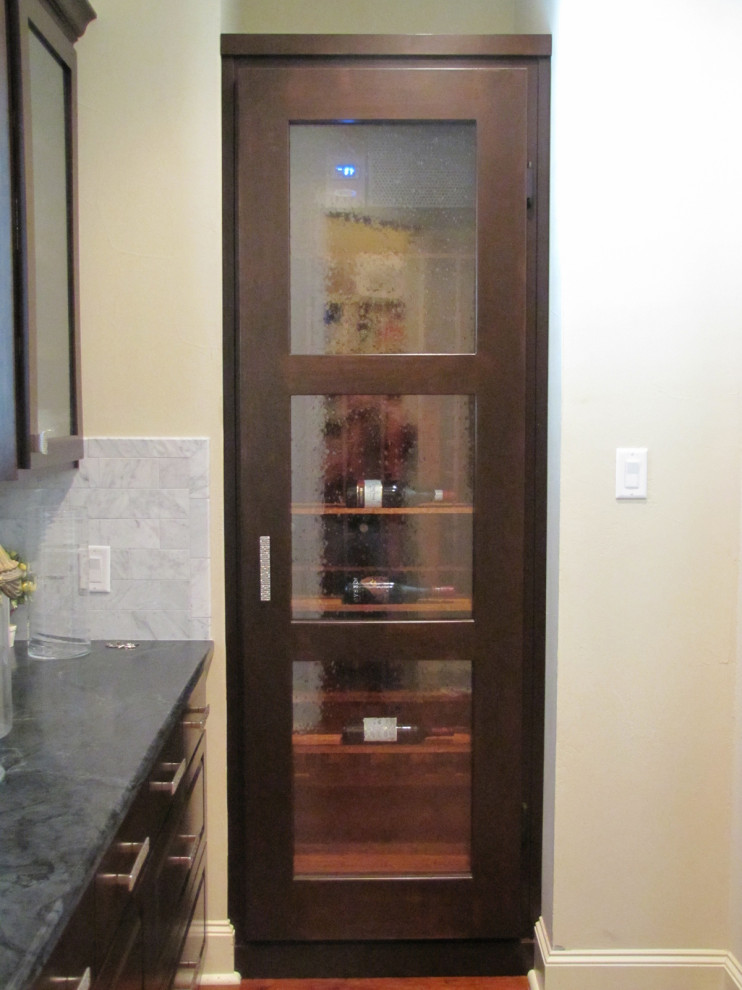 Inspiration for a small modern wine cellar in Austin with storage racks.