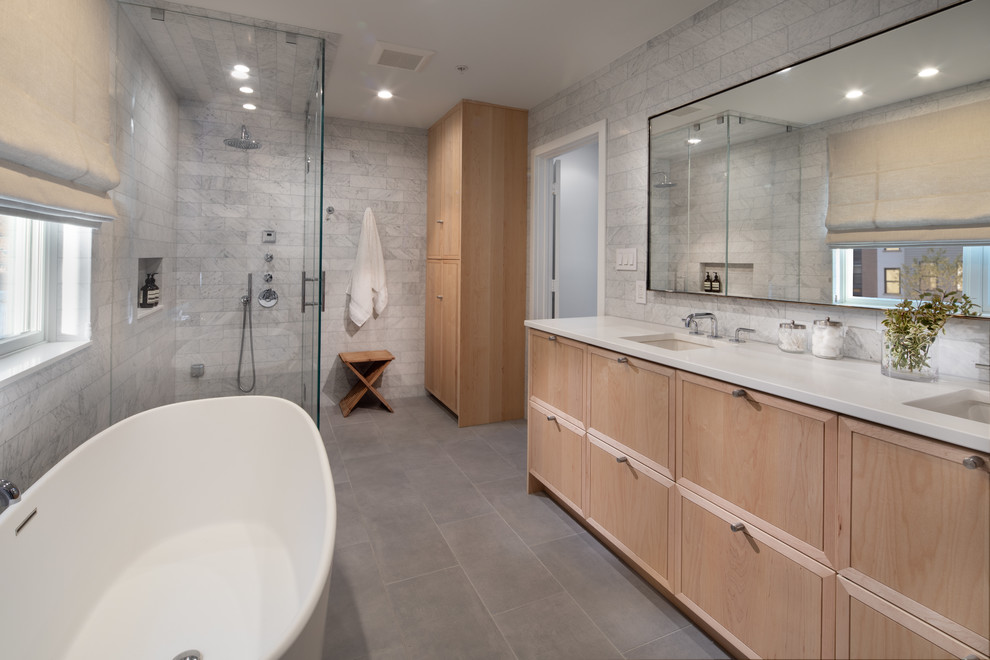 Photo of a large modern master bathroom with beaded inset cabinets, black cabinets, a freestanding tub, a curbless shower, a wall-mount toilet, white tile, subway tile, grey walls, slate floors, an undermount sink, engineered quartz benchtops, grey floor, a hinged shower door and beige benchtops.