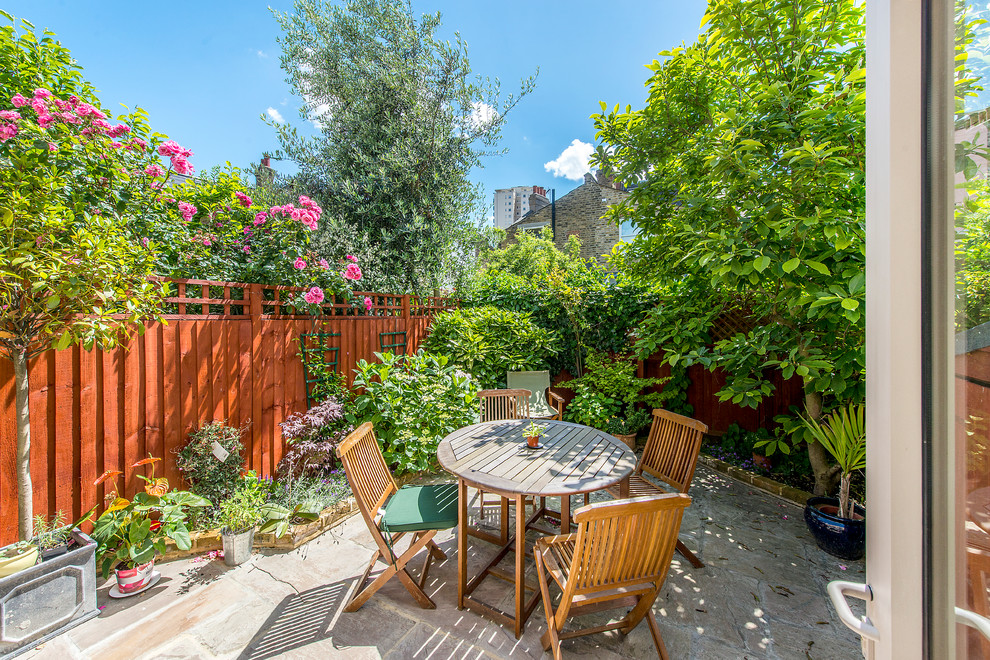 Photo of a small traditional back patio in London with no cover.