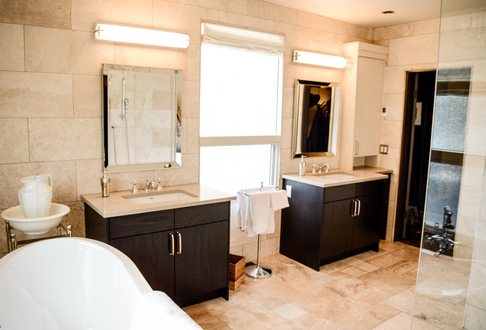 Inspiration for a mid-sized transitional master bathroom in Calgary with an undermount sink, flat-panel cabinets, dark wood cabinets, engineered quartz benchtops, a claw-foot tub, a curbless shower, beige tile, stone tile, beige walls and limestone floors.