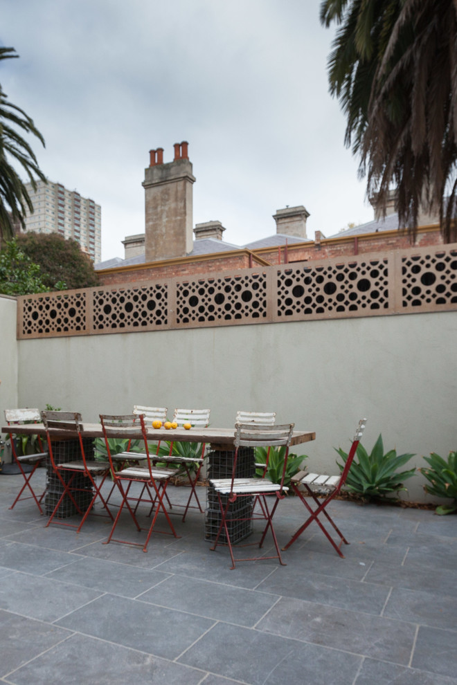 Photo of a large traditional courtyard patio in Melbourne with a vegetable garden, natural stone pavers and a pergola.