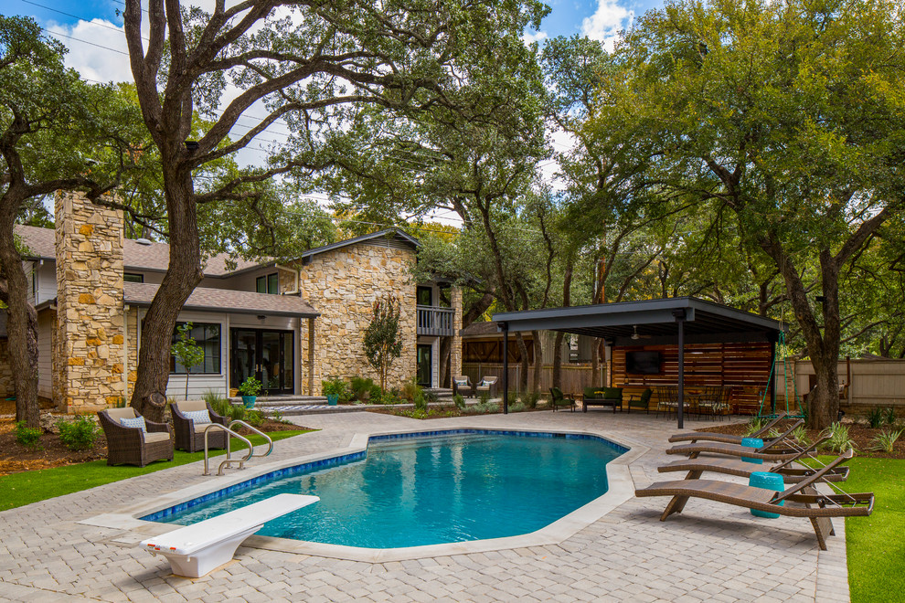 Design ideas for a mid-sized traditional backyard custom-shaped pool in Austin.