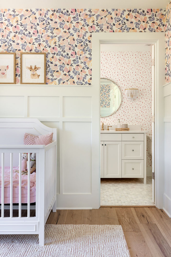 Exemple d'une chambre de bébé neutre tendance de taille moyenne avec un mur multicolore et un sol en bois brun.