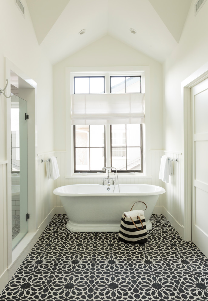 This is an example of a mid-sized country master bathroom in Los Angeles with a freestanding tub, a double shower, black tile, cement tile, white walls and cement tiles.