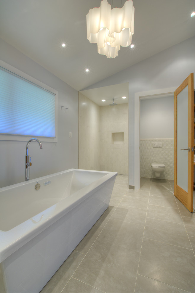 Transitional bathroom in DC Metro with a freestanding tub and an enclosed toilet.