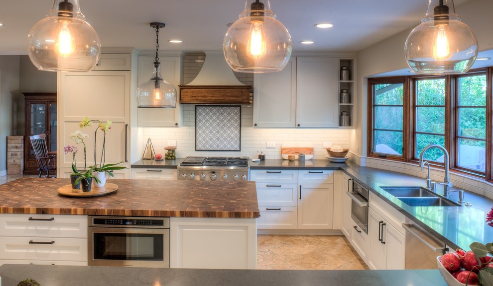 Design ideas for a mid-sized country u-shaped open plan kitchen in Denver with an undermount sink, recessed-panel cabinets, white cabinets, quartz benchtops, white splashback, stone tile splashback, stainless steel appliances, travertine floors, with island and beige floor.