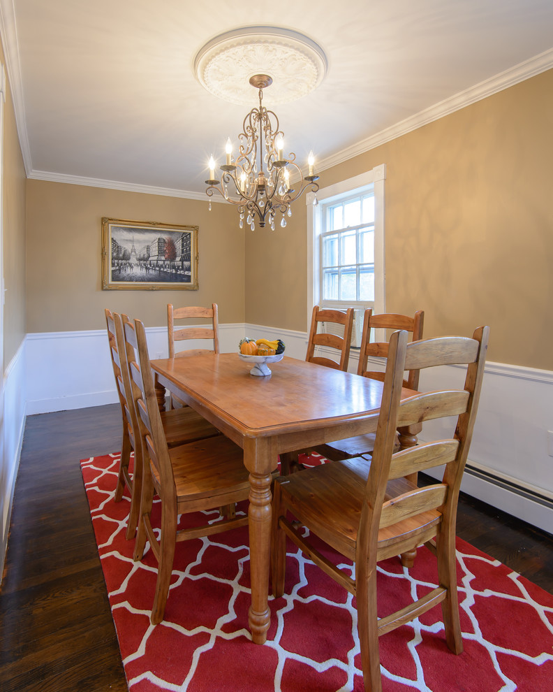Design ideas for a traditional separate dining room in Boston with brown walls and dark hardwood floors.