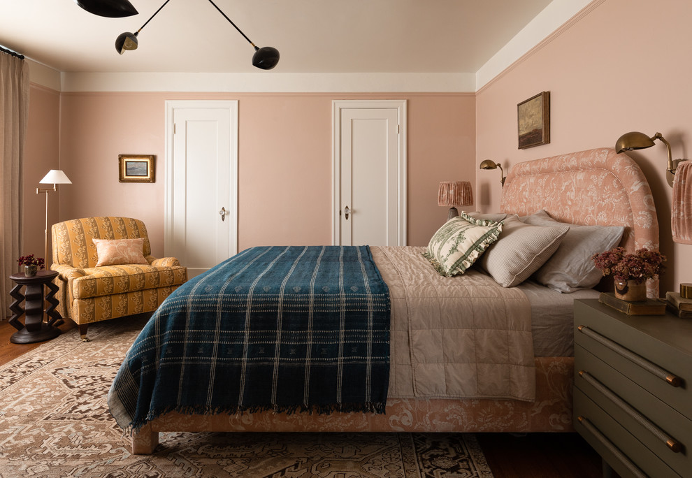 This is an example of a traditional bedroom in Seattle with pink walls, medium hardwood floors and brown floor.