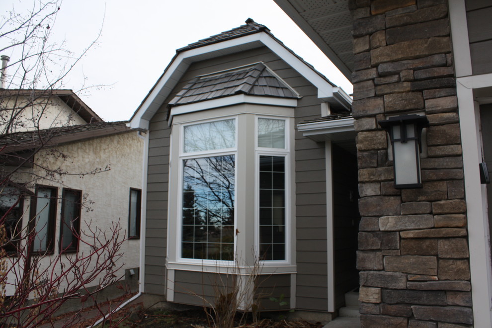 Mid-sized traditional split-level brown exterior in Calgary with mixed siding.