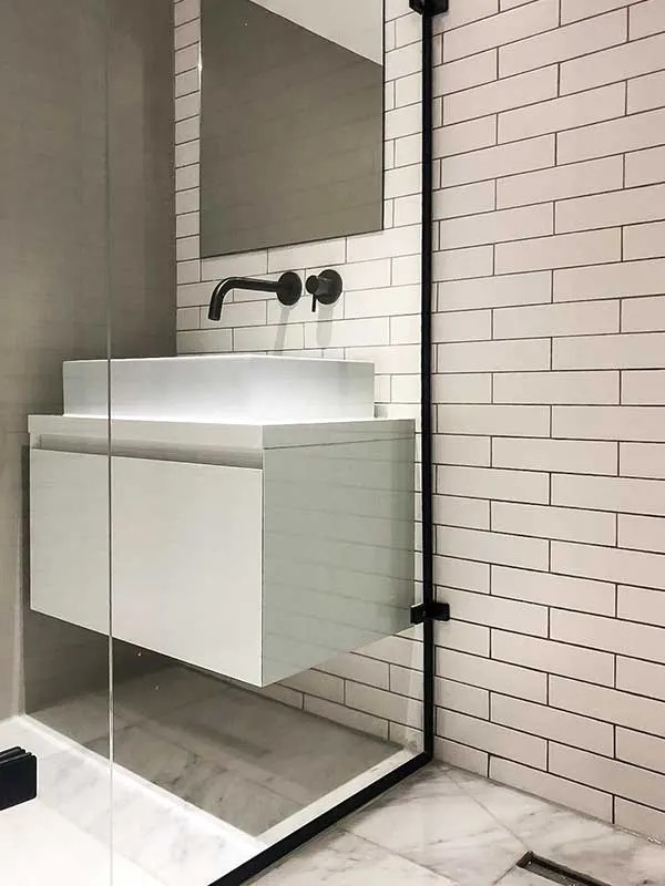 Design ideas for a small contemporary 3/4 bathroom in London with flat-panel cabinets, white cabinets, an open shower, white tile, ceramic tile, beige walls, porcelain floors, a vessel sink, laminate benchtops, multi-coloured floor, an open shower, white benchtops, a single vanity and a floating vanity.