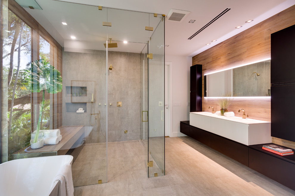 Design ideas for a contemporary bathroom in Miami with flat-panel cabinets, white cabinets, a freestanding tub, a curbless shower, brown tile, gray tile, white walls, grey floor, a hinged shower door and white benchtops.