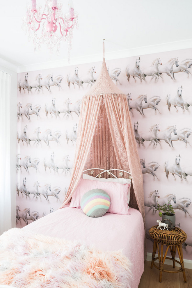 This is an example of a contemporary kids' bedroom for kids 4-10 years old and girls in Perth with multi-coloured walls, light hardwood floors and wallpaper.