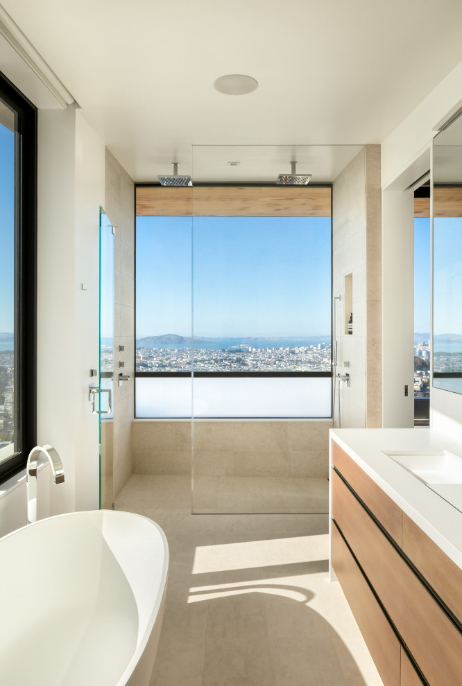 Photo of an expansive contemporary bathroom in San Francisco with flat-panel cabinets, medium wood cabinets, a freestanding tub, white walls, an undermount sink, grey floor, white benchtops, a niche and a floating vanity.