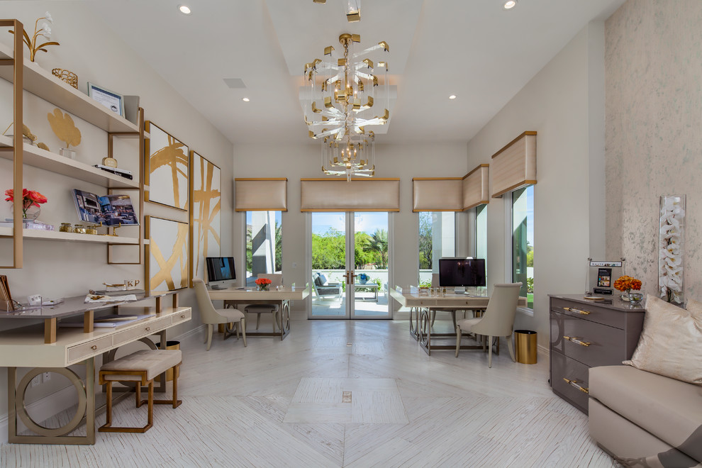 Photo of a large contemporary home office in Phoenix with white walls, light hardwood floors, a freestanding desk, white floor and no fireplace.