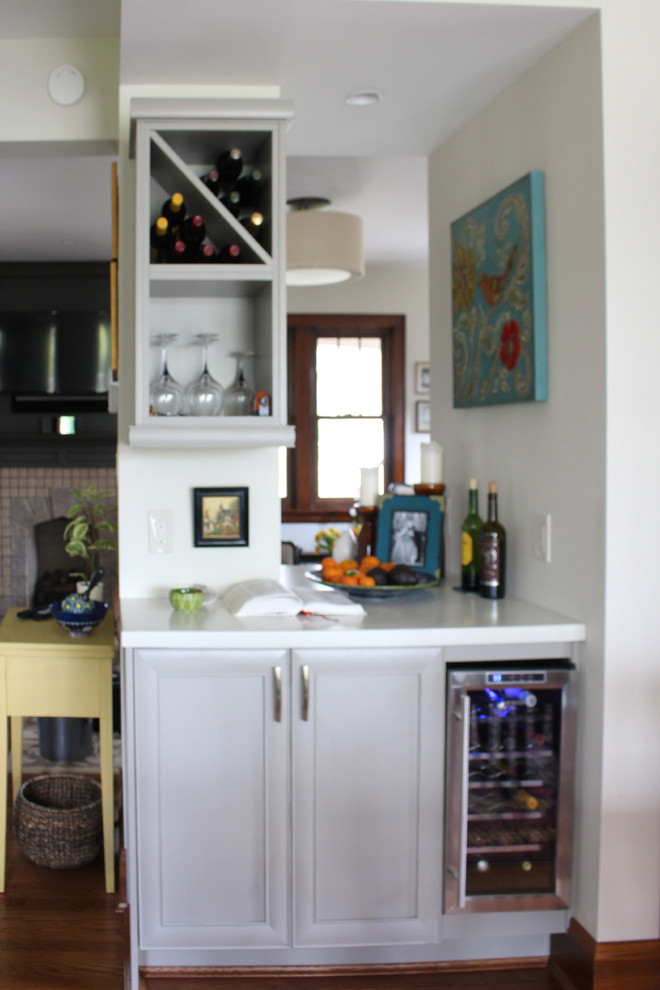 Kitchen - mid-sized transitional dark wood floor kitchen idea in Cincinnati with a drop-in sink, gray cabinets, concrete countertops, white backsplash, stainless steel appliances and an island