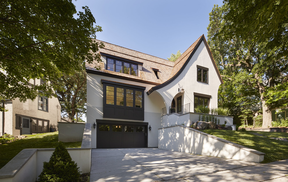 Photo of a mid-sized transitional two-storey stucco white exterior in Minneapolis with a gable roof.