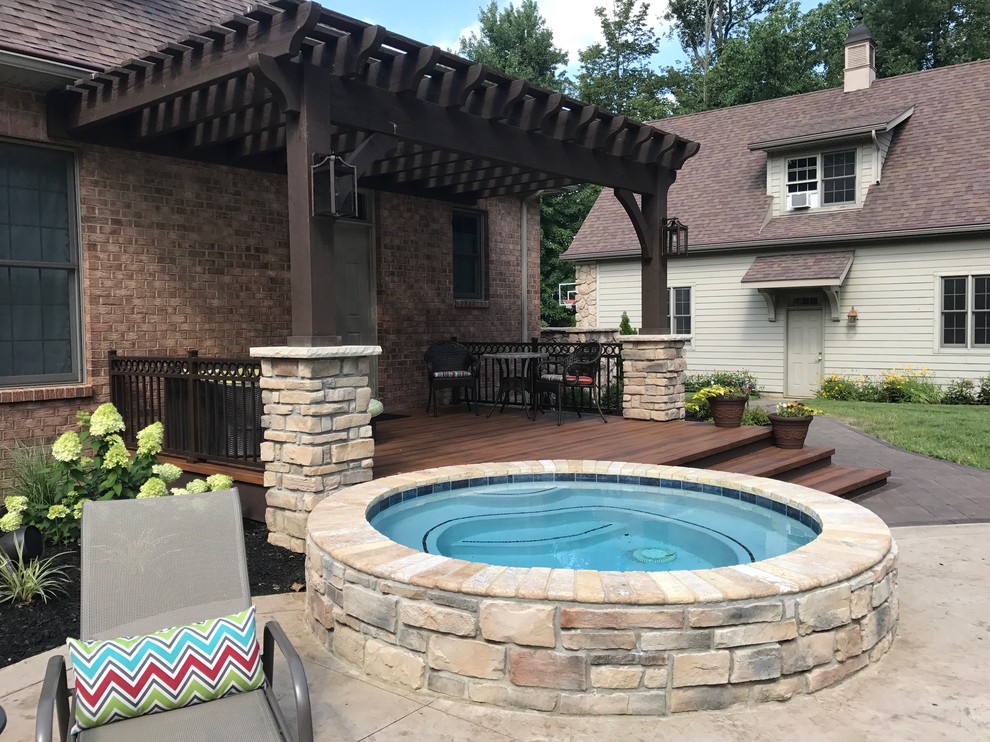 Inspiration for a mid-sized transitional backyard deck remodel with a pergola