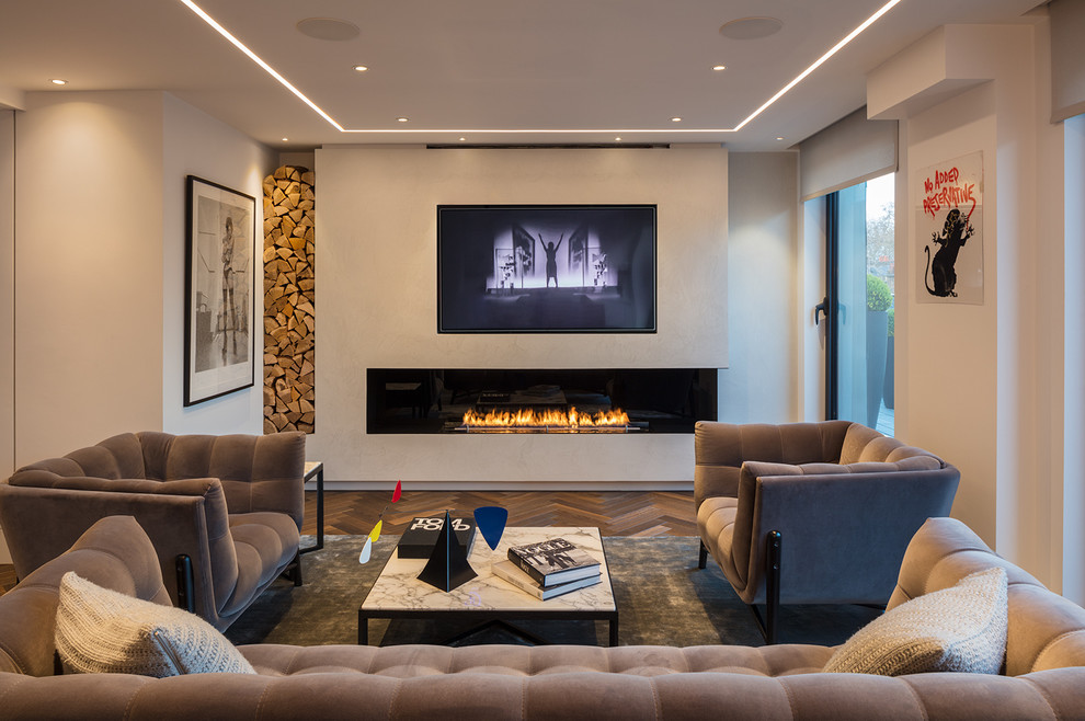 Inspiration for a mid-sized contemporary living room in London with white walls, a ribbon fireplace, a built-in media wall and brown floor.